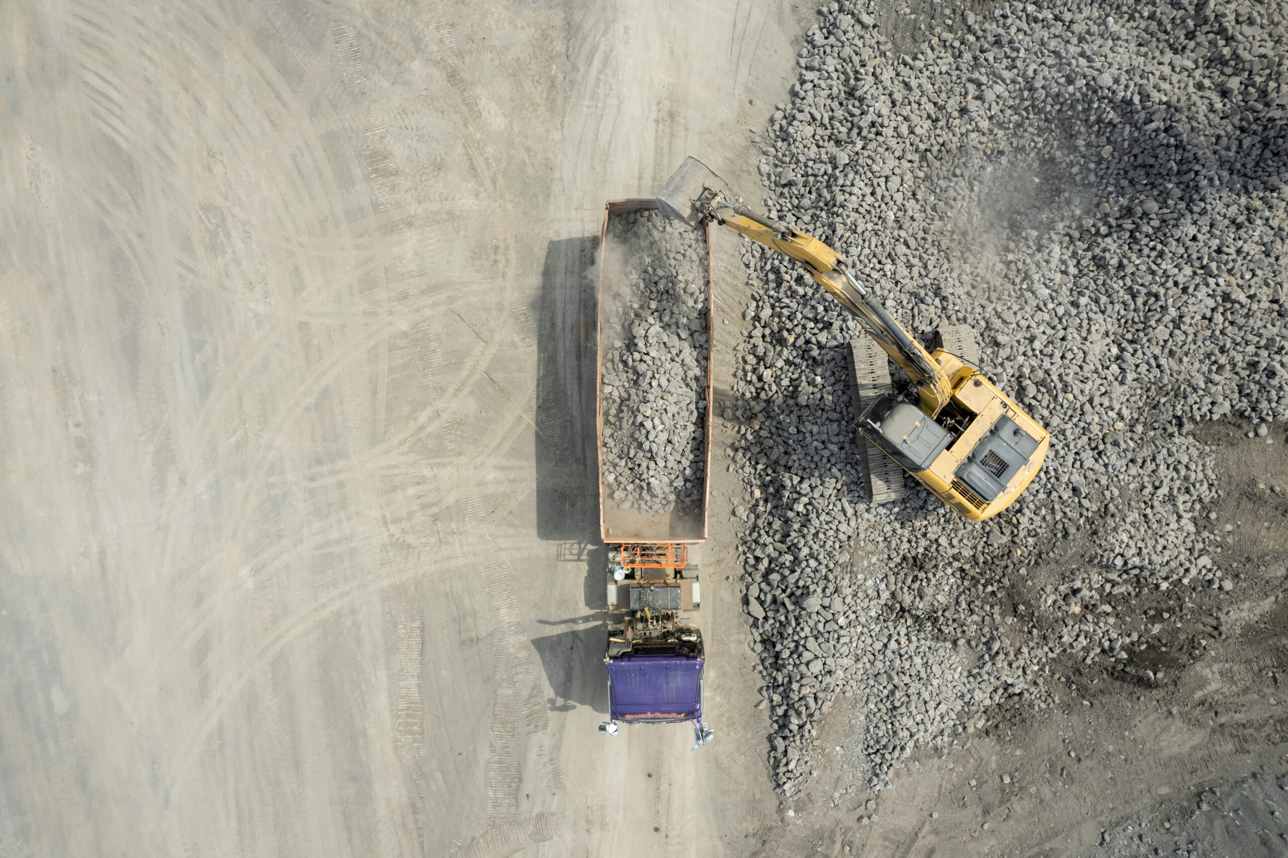 aerial view of excavator scooping rocks